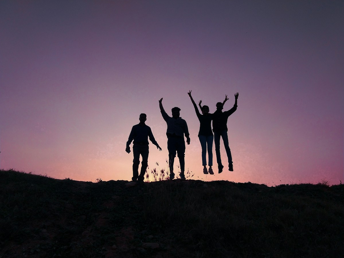 Four friends on a Bengaluru hill at sunset
